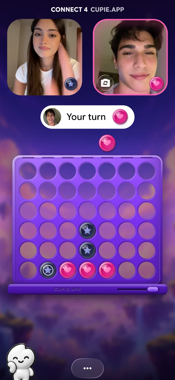 Four in a Row mid-game on a Cupie video call. Four in a Row, live on both phones